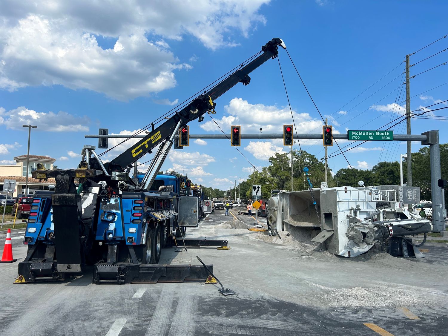 CTS rotator recovering an overturned concrete mixer at an intersection