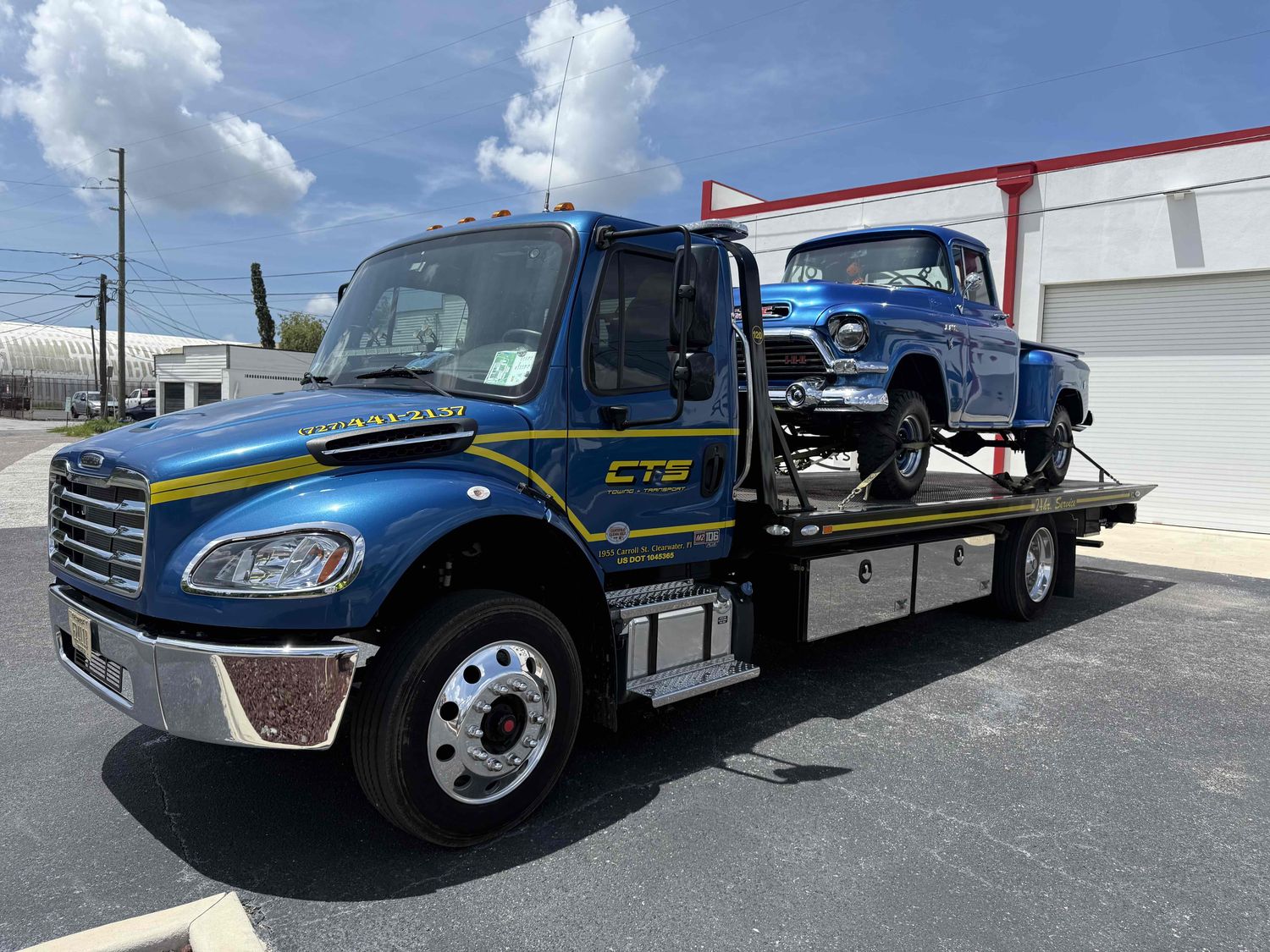 CTS flatbed rollback hauling a classic GMC pickup