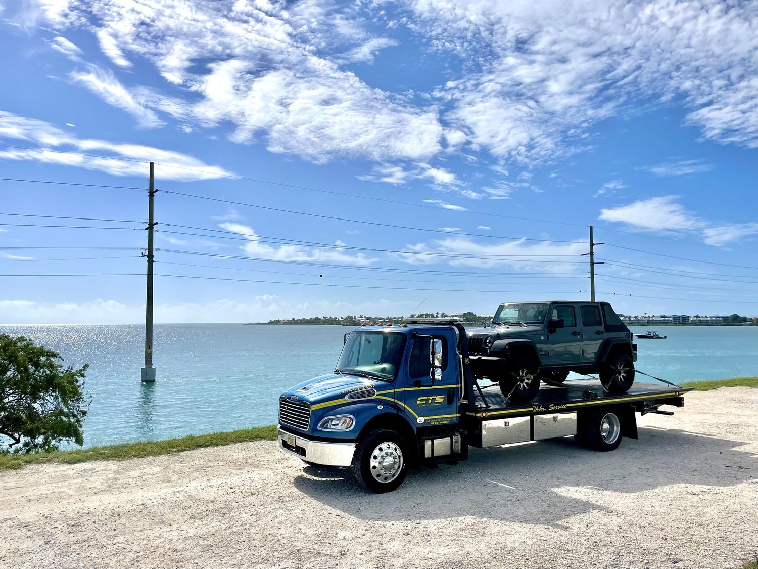 CTS rollback towing a Jeep Wrangler