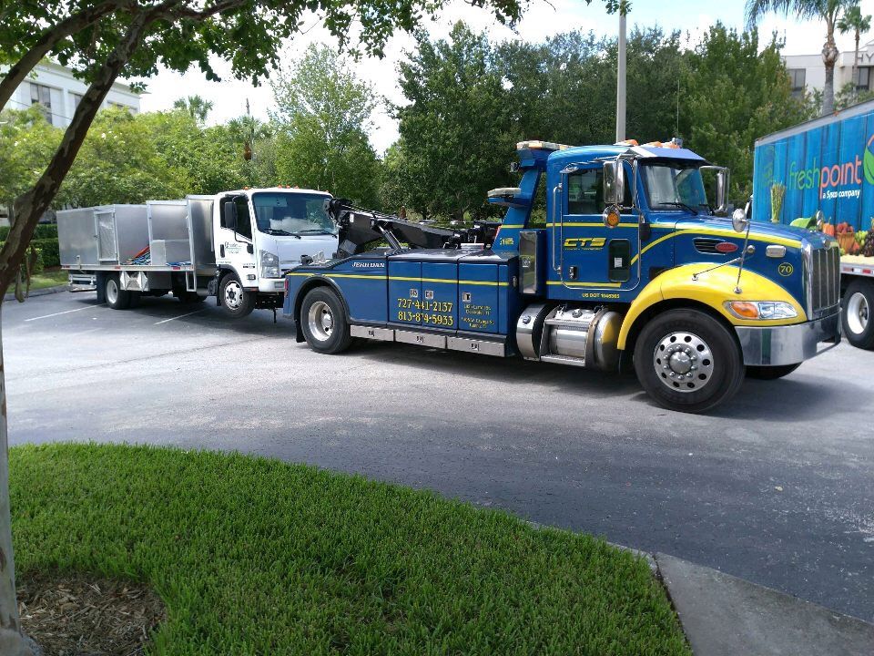 CTS wrecker towing a commercial box truck