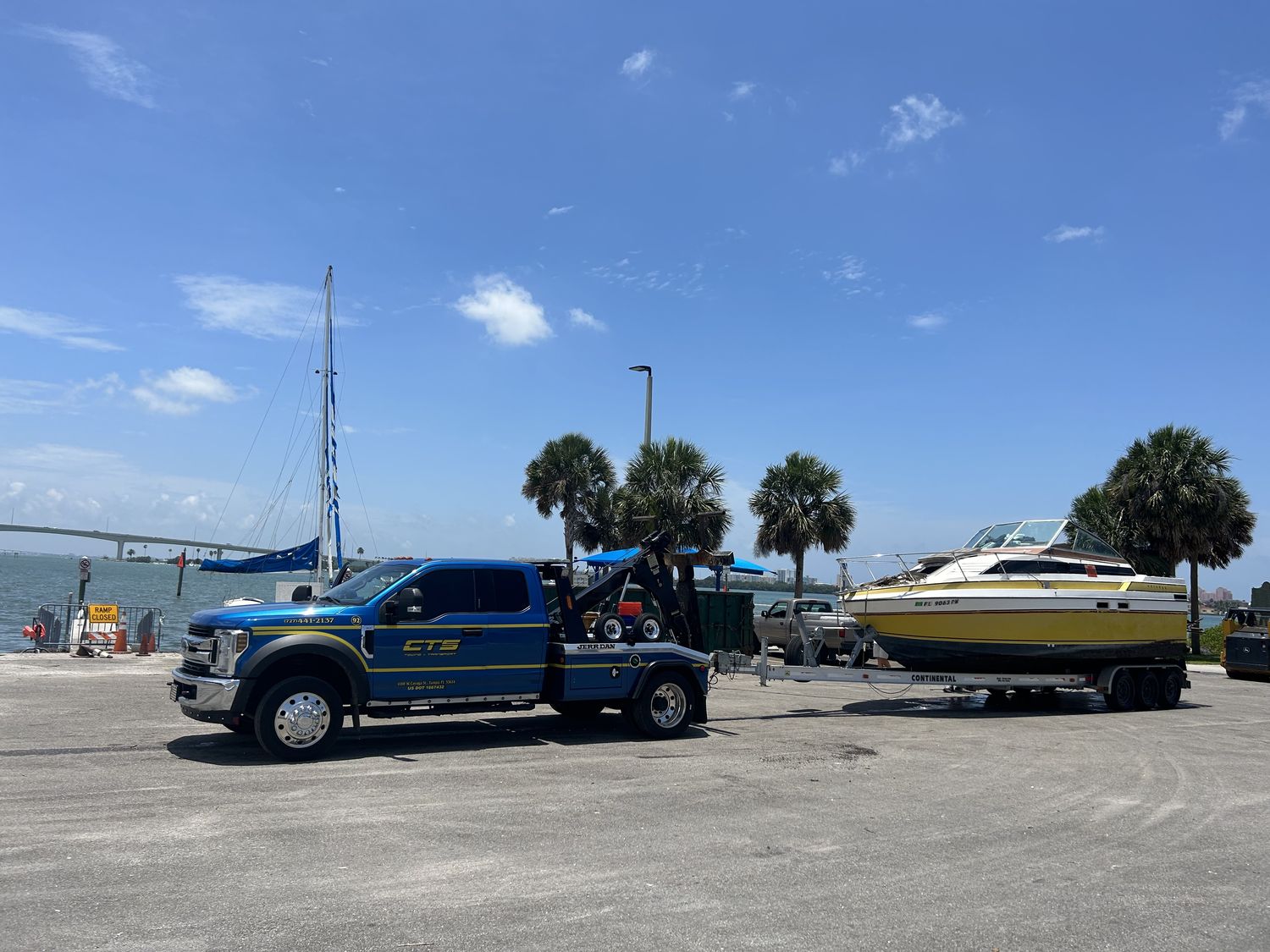 CTS towing a boat and trailer near the water