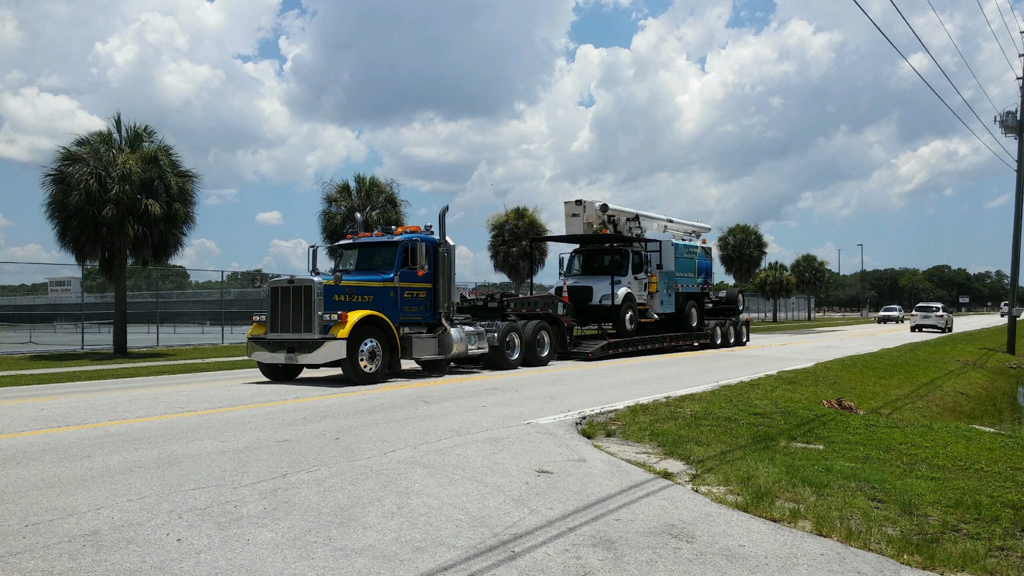 Heavy lowboy bucket truck by CTS Towing