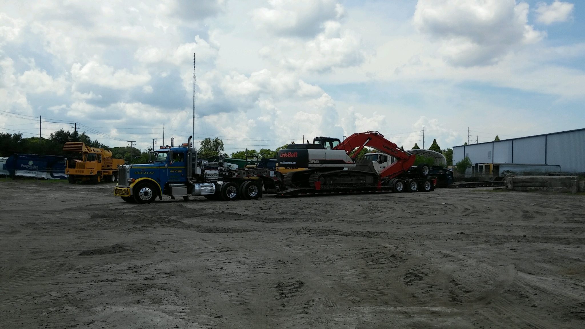 Heavy lowboy excavator tow by CTS Towing