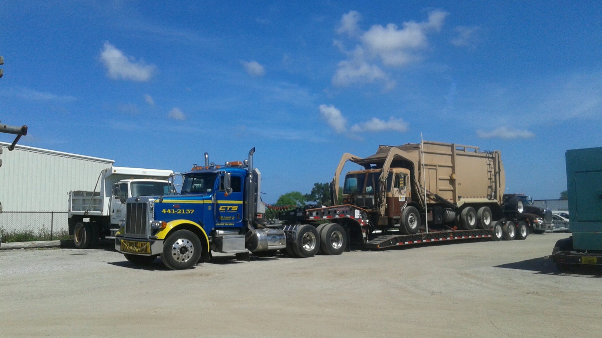Heavy lowboy garbage truck tow by CTS Towing