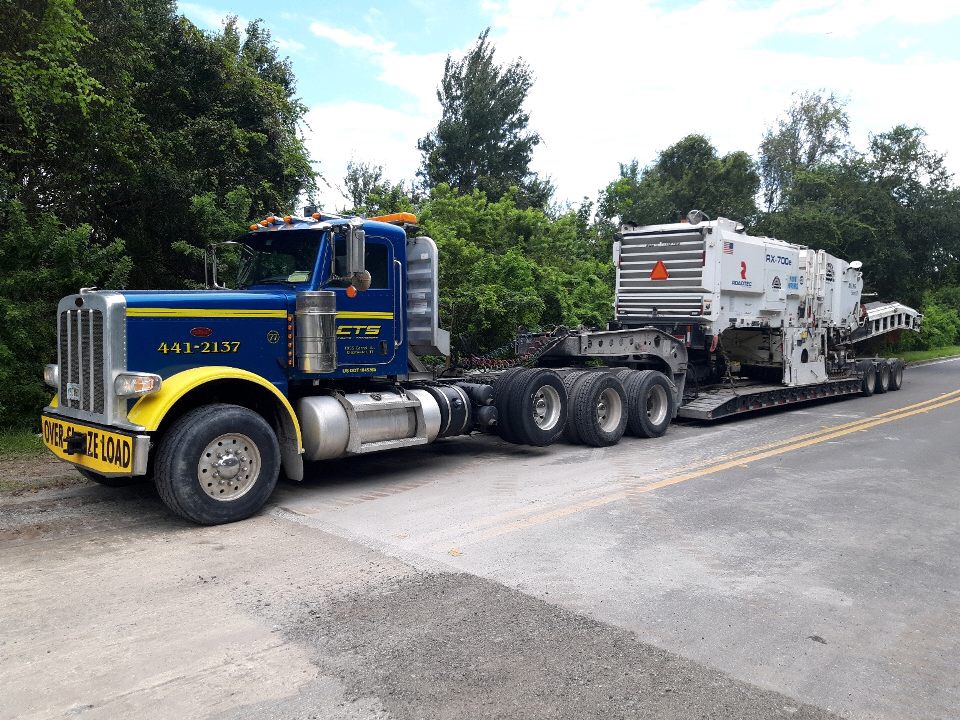 55 ton lowboy transporting a Roadtec RX70 Milling machine