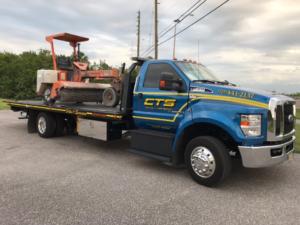 Rollback Transporting a Street Sweeper - Commercial Towing